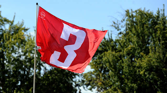A flag with Tyler Hilinksi’s No. 3 flies